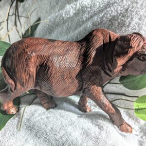 Handcrafted, hand-carved vintage brown wooden water buffalo figurine, showcasing detailed craftsmanship and rustic charm